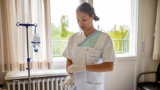 Medical worker putting on gloves