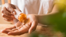 Hands dispensing pills from a bottle
