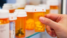 Hand and pill bottles