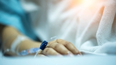 An arm with an IV and a sensor