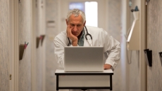 Doctor frustrated with computer.