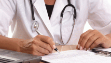 Doctor signing a piece of paper