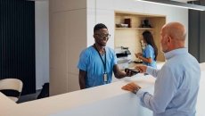 Person paying healthcare worker with credit card