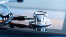 A stethoscope rests on a tablet.