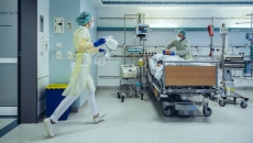 healthcare workers caring for a patient in a hospital