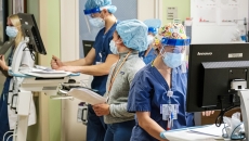 Several healthcare workers in PPE in a hospital setting