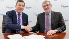 From left: John M. Murphy, MD, president and CEO of Nuvance Health, shakes hands with Northwell President and CEO Michael Dowling, at a signing ceremony.