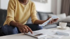 Person with papers and calculator