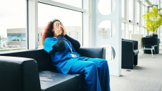 Exhausted medical worker on couch