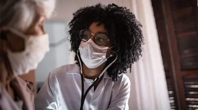 Doctor examines patient in office Doctor examines patient in office