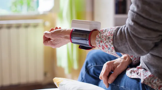 Person wearing monitoring device on wrist