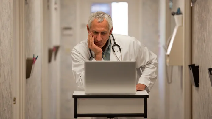 Doctor frustrated with computer.