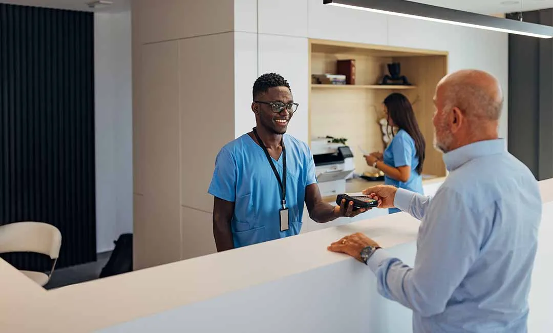 Person paying healthcare worker with credit card