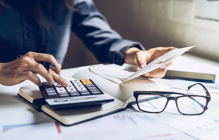 Person with bills and calculator