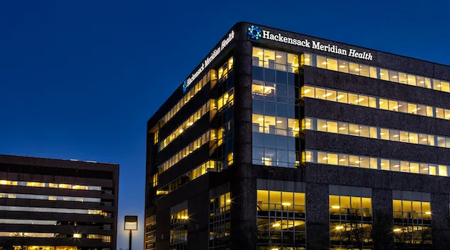 Exterior shot of Hackensack Meridian Health building at night