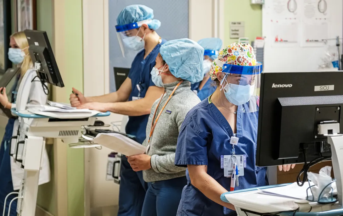 Several healthcare workers in PPE in a hospital setting