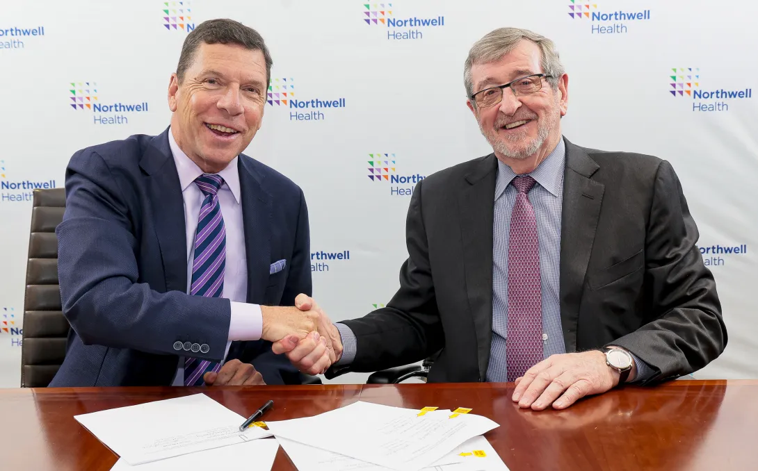 From left: John M. Murphy, MD, president and CEO of Nuvance Health, shakes hands with Northwell President and CEO Michael Dowling, at a signing ceremony.