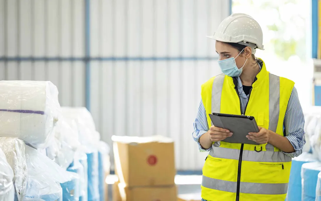 Person with clipboard in a warehouse. Photo: Nitat Termmee/Getty Images