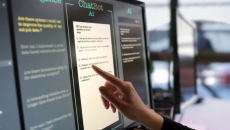 Finger pointing to a screen labeled ChatBot AI