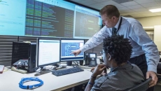 Two employees in control room
