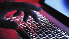 Hand on a glowing keyboard