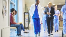 Physician and administrator in hospital lobby