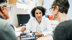 Doctor meets with a couple in office.
