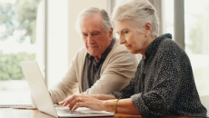 Senior couple examining medical bills