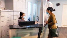 Patient at doctor's office reception desk