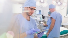 Person in scrubs with tablet