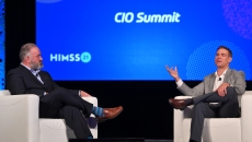 Reid Oakes, left, executive vice president of Analytics for HIMSS, talks to MLB veteran Theo Epstein about Moneyball, analytics and what they have in common with healthcare. Photo: Oscar & Associates for HIMSS