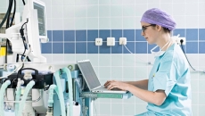 Hospital professional with laptop and equipment