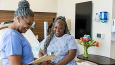Patient and nurse at office visit, both smiling