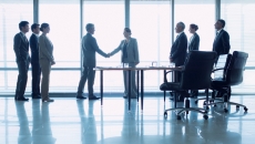 Businesspeople greet in a lobby