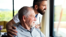 Person seated with physical therapist standing