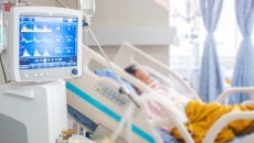 Person in hospital bed with a ventilator