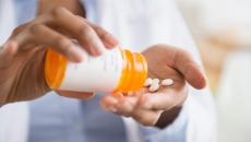 Hand dispensing pills from a bottle