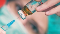 Needle drawing liquid from a vial