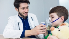 Doctor treating young asthma patient.