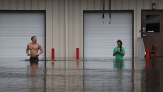 People in a flooded storefront.