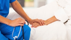 Medical doctor comforting senior patient