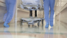busy doctors pushing gurney