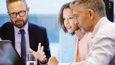Executives having discussion at board table