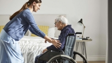 Nurse assisting elderly patient