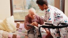nurse helping elderly man in hospice care