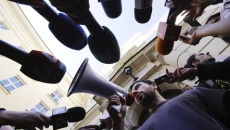 person using a megaphone into mircophones