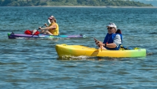 middle aged couple in kayaks