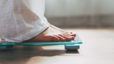 Close-up of feet on a scale