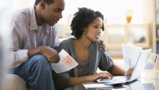 A couple goes over bills, including healthcare bills