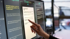 Finger at touchscreen labeled ChatBot AI